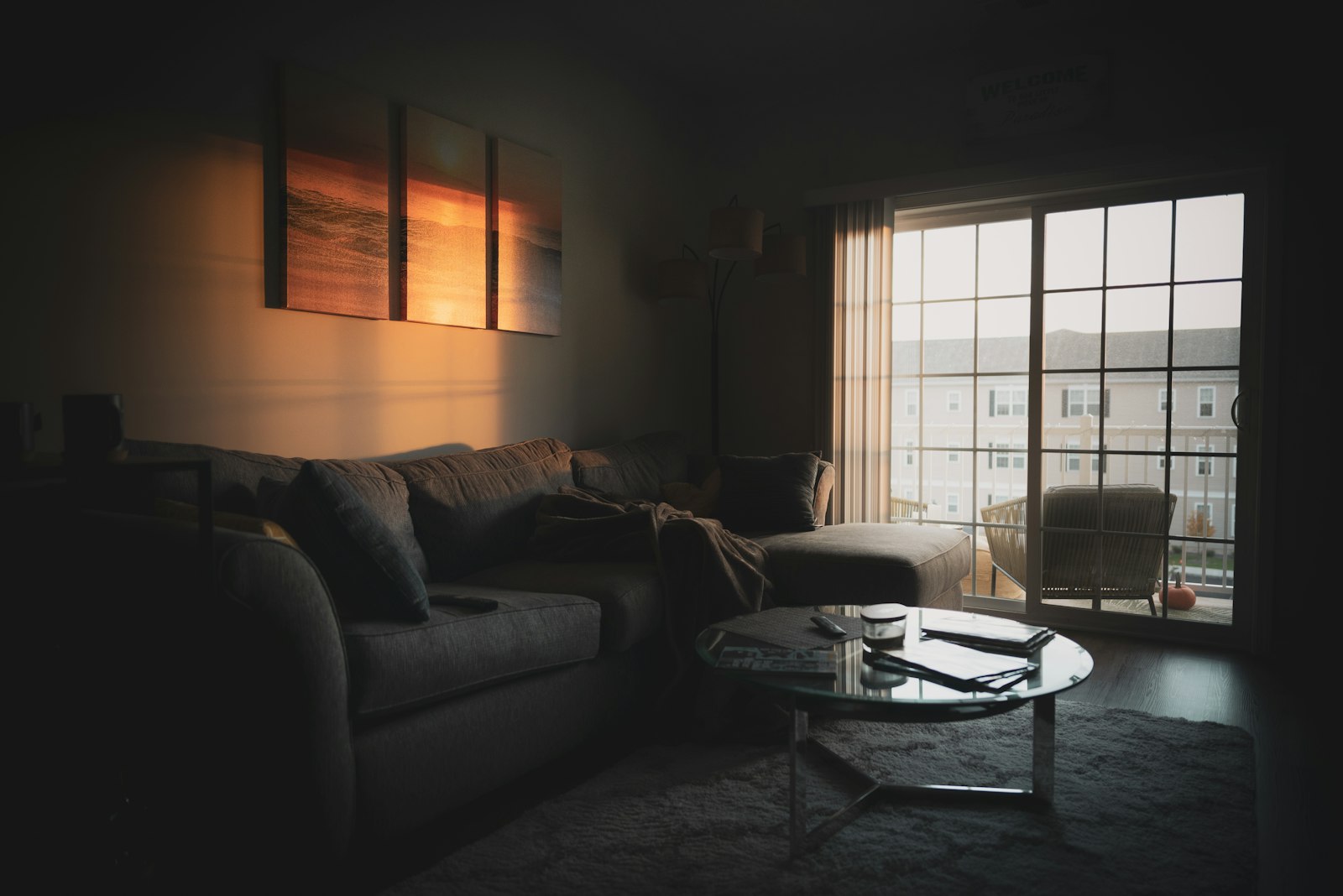 Ruime stoffen driezitsbank tegen een lichte wand in een woonkamer met daglicht