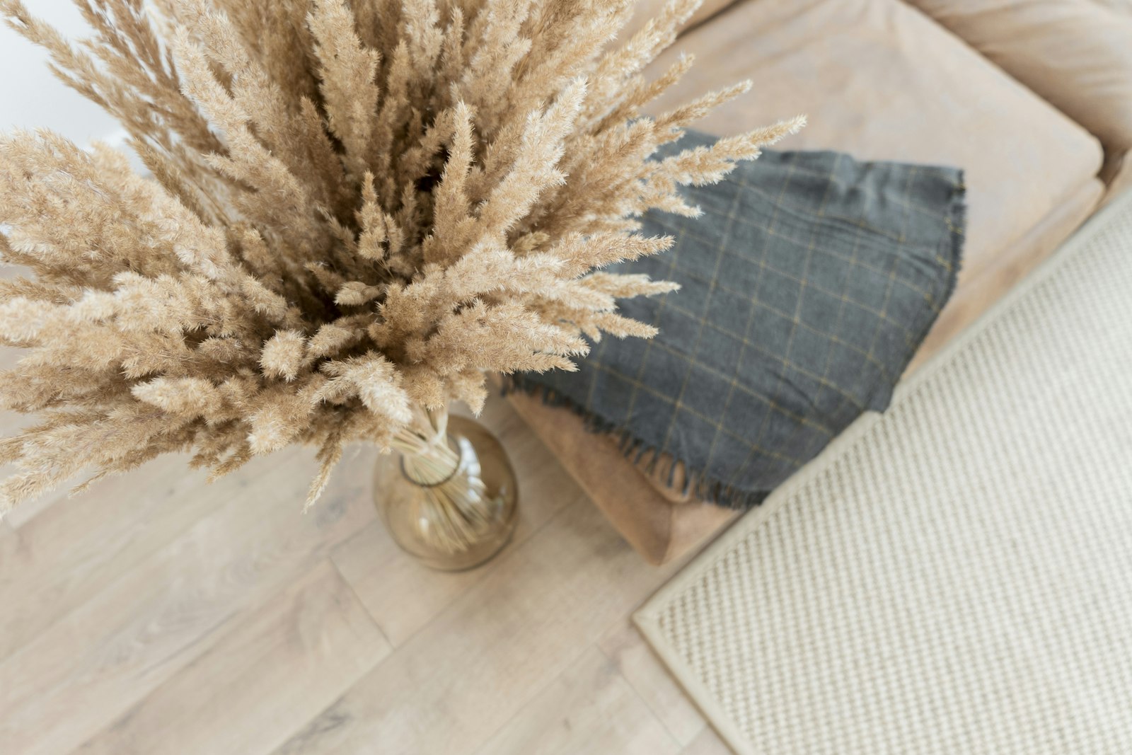 Woonkamer in warm minimalisme met een zandkleurige bank en houten tafel